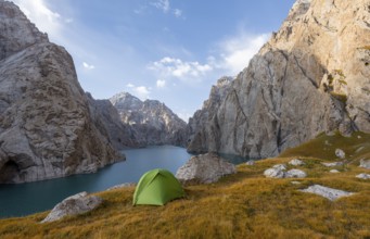 Wild camping, camping in the wilderness with a tent in front of mountain lake Kol Suu, Sary Beles