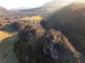 An aerial view shows a valley with a castle in the shadow of the evening sun, St Pankraz,