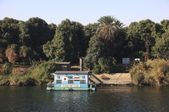 Floating pumping station, houses along the Nile, between Luxor and Esna, Africa, Upper Egypt