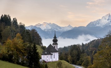 Maria Gern pilgrimage church at sunrise, behind Schönfeldspitze and the Watzmann, in autumn,