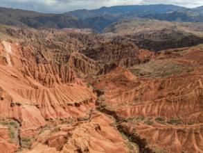 Eroded mountain landscape, canyon with red and orange rock formations, aerial view, Konorchek