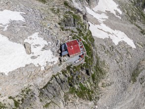 Aerial view of mountain hut Cabane de l'A Neuve, located on a steep rock formation, near La Fouly,