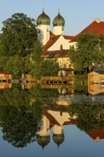 Romanesque Benedictine Abbey Seeon Monastery, monastery church St. Lambert with reflection in the