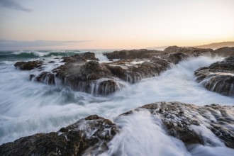 Waves washing over rocks by the sea, long exposure, coastal landscape at sunset, Playa Cocalito,