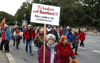 A demonstrator carries a placard with the inscription Peace with Russia during the demonstration