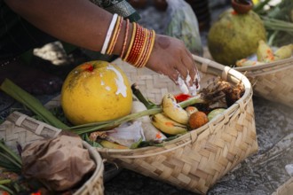 Hindu devotees perform rituals as they offer prayers to the Sun god in the bank of Brahmaputra