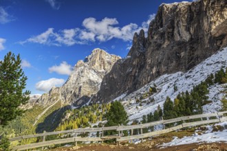 The rocky Sella Group mountain landscape in the South Tyrolean mountains with a wooden fence and