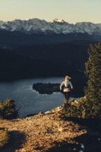 Trail running in autumn on the Jochberg on Lake Walchensee against the wonderful backdrop of the