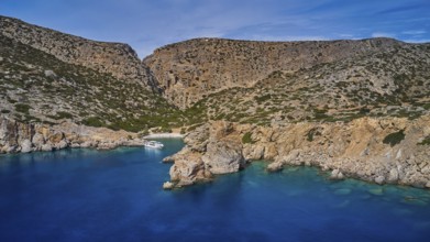 Palatia Beach, Palatia, bay with clear water and natural cliffs, a boat in the bay, boat tour