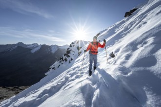 Mountaineers on a hiking trail with snow, ascent to Ramoljoch, autumnal mountain landscape,