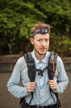 Tourist with headlamp and rucksack in the rainforest, Corcovado National Park, Osa Peninsula,