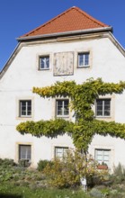 Gable of an old renovated farmhouse with sundial, village centre of Pennrich, Dresden, Saxony,