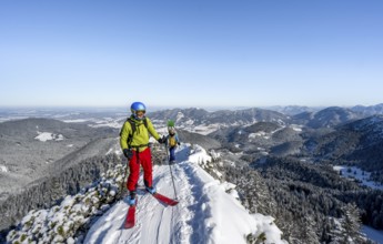 Two ski tourers on a mountain ridge, on the ascent to the Teufelsstättkopf, snowy mountain