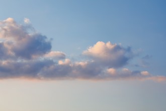 Pink-coloured spring clouds adorn the evening sky at sunset