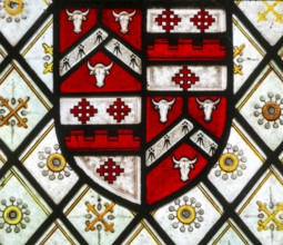 Detail of stained glass east window with heraldic design, church of All Saints, Rede, Suffolk,