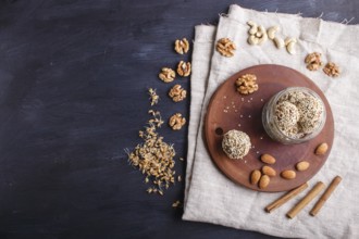 Energy balls cakes with almonds, sesame, cashew, walnuts, dates and germinated wheat on wooden