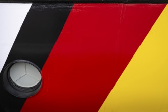 Black, red, gold, colours of the German flag on the ship's hull, Norddeich, East Frisia, Lower