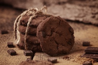 Dark chocolate cookies, with chocolate chips, on a wooden table, selective focus, close-up, no