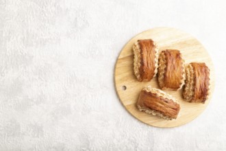 Traditional armenian dessert gata on a gray concrete background and wooden board. top view, flat