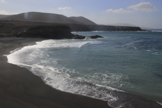 Waves breaking on black sand beach at Ajuy, Fuerteventura, Canary Islands, Spain, Europe