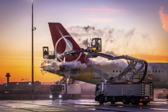 Frost at the airport, a Turkish Airlines aircraft is de-iced in front of sunrise. Airbus A321-231,