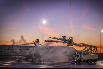 Frost at the airport, a Turkish Airlines aircraft is de-iced in front of sunrise. Airbus A321-231,