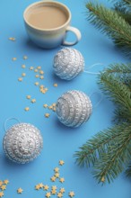 Christmas or New Year composition. Decorations, silver balls, fir and spruce branches, cup of