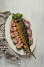 Smoked mackerel, top view, with spices, on a wooden table, no people, selective focus