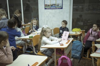 Pupils in a classroom in one of the metro schools in Kharkiv. Classrooms were set up in various