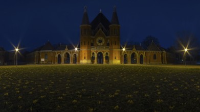 Main entrance of the cemetery in Hanover Stöcken with a lawn with crocuses in the foreground, dutch