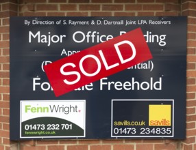 Close up of Sold estate agent sign for major office building commercial property, Ipswich, Suffolk,