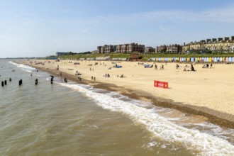 People enjoying sunny weather on sandy South Beach, Lowestoft, Suffolk, England, UK