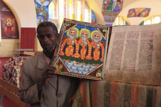 Tigray region, Axum, Aksum, St Mary's Cathedral, Maryam Tsion, inside, church servant shows old