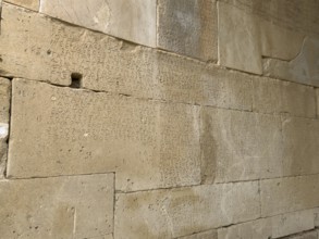 Detailed view of sandstone blocks Stones made of sandstone with written laws carved into the wall