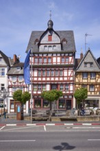 Multi-storey half-timbered house and European flag on the main street in Adenau, Eifel, Ahrweiler