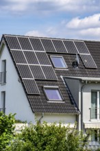 Solar roof, solar panels on a pitched roof of a residential building, renewable energy generation