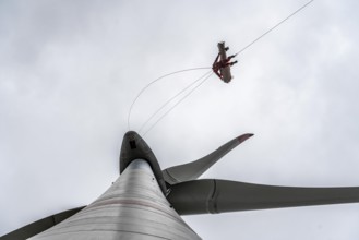 Height rescuers from the Oberhausen professional fire brigade practise abseiling from a wind