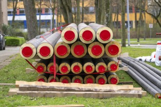 Pipe for district heating connections lying on a construction site on a stockpile, to be laid to