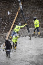 Construction site, concreting, the foundation of a building is concreted, the concrete is pumped