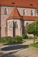 Church of St. Nicholas, façade, windows, roofs of red plain tiles, trees, greenery, sunlight,