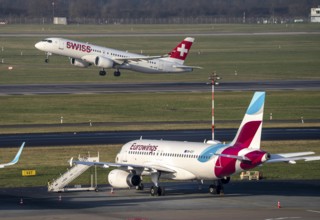 Düsseldorf Airport, Eurowings and aircraft on the apron and Swiss aircraft taking off, North