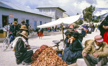 Subtitle: Border town Peru possibly Puno, Peru, South America, 1962 Street market with a pile of