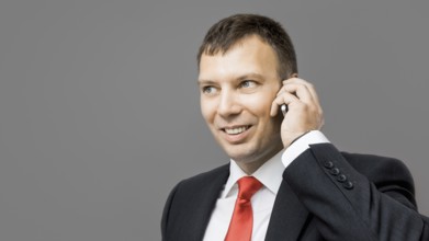 An image of a handsome business man and his mobile phone