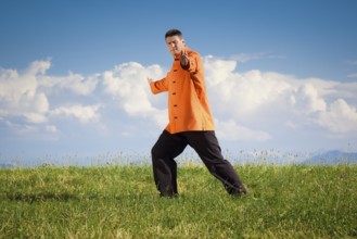 A man doing Qi-Gong in the green nature