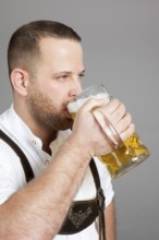 An image of a young bavarian with a beer