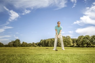 A picture of a young male golfer on the green