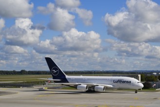 Lufthansa Airbus A380-800 taxiing under blue sky from Runway North on Apron 2 East to Terminal 2,