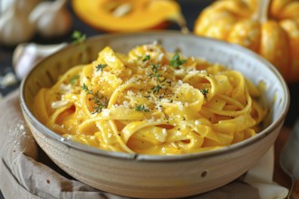 Bowl with creamy pumpkin pasta with Parmesan cheese. Generative Ai, AI generated