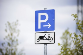 Symbolic photo. A sign for reserved parking spaces for cargo bikes on a newly built car park.