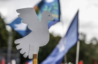 Demonstrator holding a peace dove during the demonstration Never again war, Berlin, 03.10.2024. The